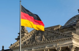 The German flag fluttering in front of Reichstag building. GettyImages/arsenisspyros