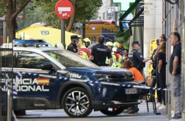 Police and emergency service workers are seen near the site of a collapsed building which was being refurbished in Madrid on October 7, 2025.