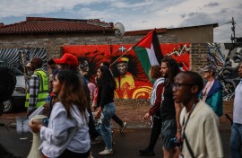 Protesters from South African Christians for Palestine and the Muslim community hold pro-Palestinian posters and flags during their march in Soweto 