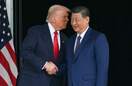 US President Donald Trump (L) and China's President Xi Jinping shake hands as they leave after their talks at the Gimhae Air Base. Photo by Andrew Caballero-Reynolds/ AFP 