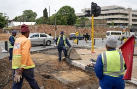 Road maintenance workers gather in a street under renovation in Braamfontein, Johannesburg, on November 7, 2025.