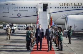 Britain's Prime Minister Keir Starmer (C-L) is welcomed by a South African representative upon his arrival at OR Tambo International Airport in Ekurhuleni on November 21, 2025 ahead of the G20 leaders' Summit.