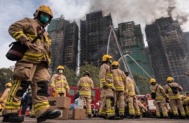 Hong Kong firefighters scouring the apartment complex after the blaze tore through the high-rises. AFP/Dale De La Rey