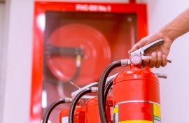 A person with fire extinguishers and a hose. GettyImages/EyeEm Mobile GmbH