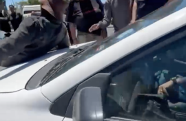 The victim on the hood of the car.