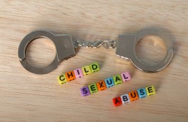 The words 'Child Sexual Abuse' with handcuffs. GettyImages/Abu Hanifah