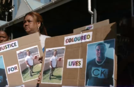 Community members protesting outside court.