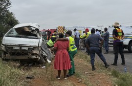 A rescue worker (2nd L) comforts a woman (L) at the scene of the Vaal accident. AFP/John Mkhize