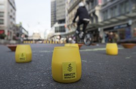 File: The logo of Amnesty International on candles. Filip de Smet/Belga via AFP