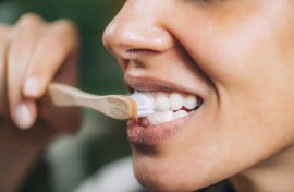A woman brushing teeth with toothpaste. Microgen Images/Science Photo Library via AFP