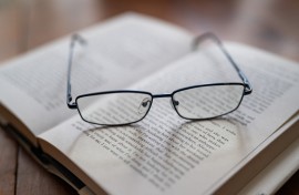 Reading glasses placed on an open book. Jean-Marc Barrère/Hans Lucas via AFP