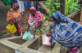 Women with buckets getting tap water. Emmanuel Herman/Xinhua via AFP