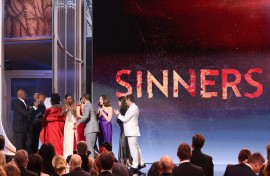 The cast of "Sinners" arrive onstage to accept the award for Outstanding Performance by a Cast in a Motion Picture. AFP/Valerie Macon