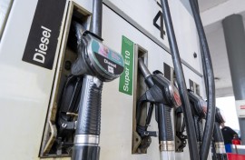 File: Fuel nozzles hang in the holder at a filling station. Peter Kneffel/dpa via AFP