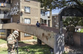 Police officers and soldiers search a building during a patrol operation in Westbury. AFP/Ilaria Finizio