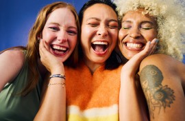 Three women laughing together. GettyImages/pixdeluxe