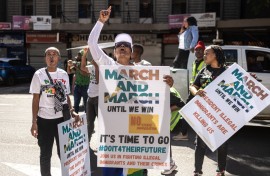 Protesters chant slogans and hold placards at a protest march against undocumented migrants. AFP/Emmanuel Croset