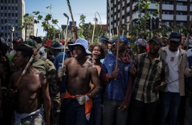 Protestors hold branches and sticks during a protest march against undocumented migrants organised by “March and March” in Johannesburg on April 29, 2026.