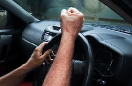 File: An angry car driver pulls a fist at another motorist. GettyImages/brazzo