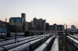 A general view of Shosholoza Meyl train carriages with the skyline of Braamfontein, Johannesburg, in the background on March 28, 2026. (Photo by Wikus de Wet / AFP)