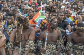 A South African flag is seen in a protester's head gear as he gathers with other protesters during a protest march against undocumented migrants in Durban on May 6, 2026.