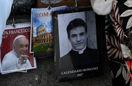 A calendar displaying a picture of Giovanni Galizia dressed as a priest is on sale in a souvenirs shop. AFP/Andreas Solaro