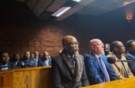 Vusimuzi 'Cat' Matlala in court, behind him is suspended SAPS National Commissioner General Fannie Masemola.