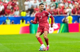 Portugal's #7 forward Cristiano Ronaldo, passes the ball. McGuelber / Odyssey Images via AFP