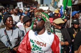 Protesters chant slogans as they march during a demonstration by the "March and March" and Operation Dudula movements. AFP/Phill Magakoe