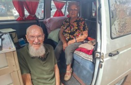 Elderly couple sitting in their Kombi that they use to travel throughout the Kruger national park