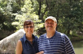 Couple standing next to each other against a park backdrop