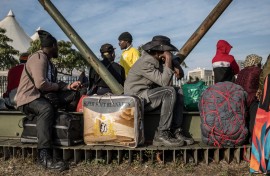 Undocumented migrants line up for transport to their home countries. AFP/Marco Longari