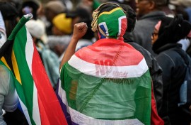 Protesters chant slogans as they march during a demonstration by the "March and March" and Operation Dudula movements. AFP/Rodger Bosch