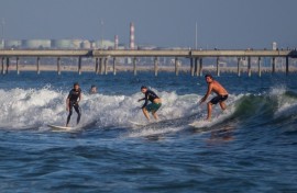 Surfers catch a wave at Venice Beach in Los Angeles, California. AFP/Apu Gomes