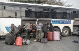 Documented foreign nationals pack their belonging in a bus in Durban for relocation to the Lindela Repatriation Centre in Gauteng. AFP/Rajesh Jantilal