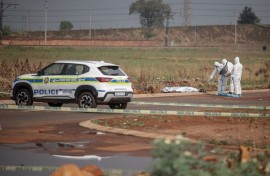 Members of the South African Police Service (SAPS) Forensic Pathology Services work on the crime scene where the body of a woman was discovered in Boksburg. AFP/Emmanuel Croset