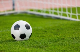 Closeup of a soccer ball and goalpost. GettyImages/artisteer