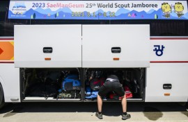 Scouts prepare to leave the  World Scout Jamboree camspite in South Korea's North Jeolla province, which has been plagued by problems and is being evacuated as a typhoon approaches