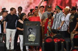 US rapper DJ Kool Herc (R) recieves the Cultural Impact Award during the Hip Hop 50 Live concert, which marked five decades of the genre