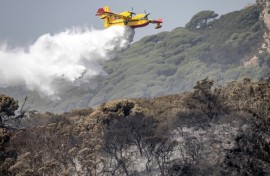A Royal Moroccan Air Force firefighting plane douses a wildfire in Tangier