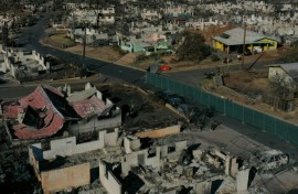 An aerial image shows destroyed homes and vehicles in the aftermath of the Maui wildfires in Lahaina, Hawaii on August 17, 2023