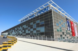 Flags of Turkey and breakaway North Cyprus hang on the facade of the new terminal for its inauguration