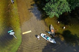 People prepare to kayak through the flooded streets of Crystal River, Florida, amid flooding caused by Hurricane Idalia