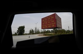 Political propaganda bearing the "Twelve Socialist Core Values" is seen on the road outside Yarkant in northwestern China's Xinjiang region