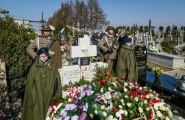 Soldiers stand guard as people lay wreaths  during a ceremony at the grave of The Ulma family