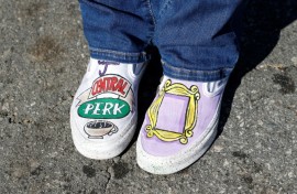 A fan wearing 'Friends'-themed shoes pays respects outside the Los Angeles house of actor Matthew Perry on October 29, 2023