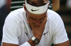 Hurt: Nadal at Wimbledon in 2022 where he had to forfeit his semi-final with an abdominal tear