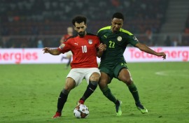 Egypt captain Mohamed Salah (L) fights for the ball  with Senegal forward Mame Thiam during the 2022 Africa Cup of Nations final in Yaounde.
