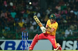 Zimbabwe's Luke Jongwe celebrates with Sikandar Raza (R) after taking the wicket of Sri Lanka's Kusal Mendis (L) during the second T20 between Sri Lanka and Zimbabwe