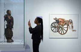 A statue stolen from a Congolose chief stands in the museum as "A Symbol of Stolen Art" as part of an exhibition highlighting the colonial-era plunder
